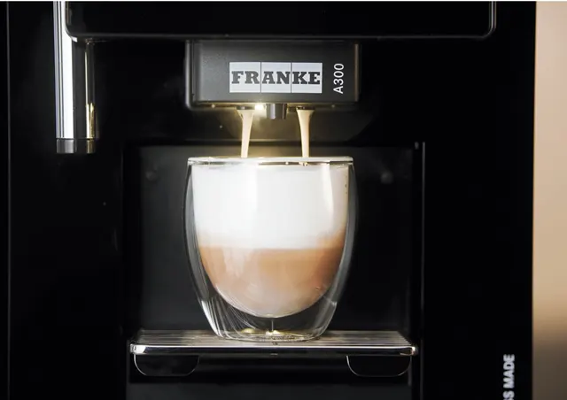 Franke A300, coffee with milk pouring into a glass, close-up