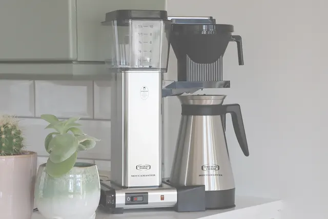 Moccamaster KBGT Silver in a kitchen by a tiled wall