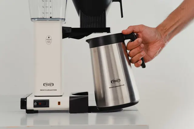 Moccamaster KBGT White with the thermal jug held in a hand