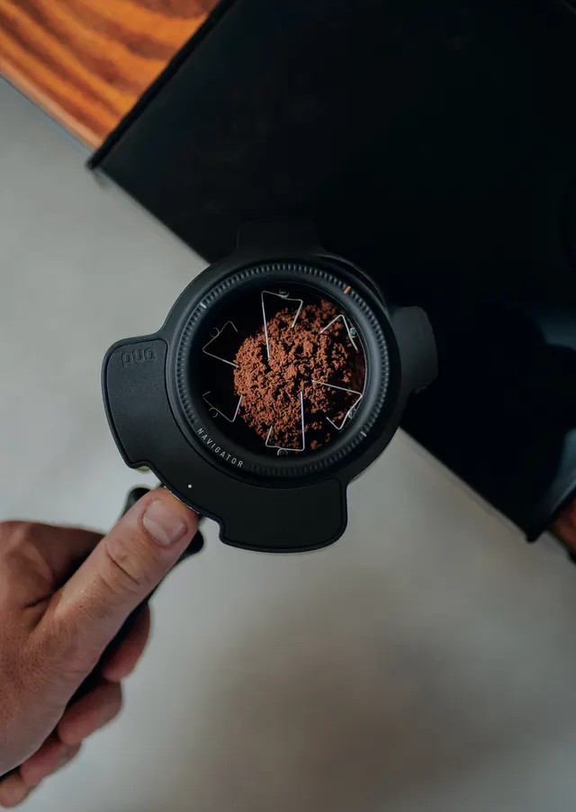 Puq Prep Navigator on a portafilter with ground coffee