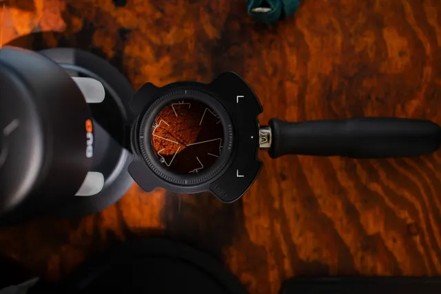 Puq Prep Navigator in a portafilter next to a PUQ tamper